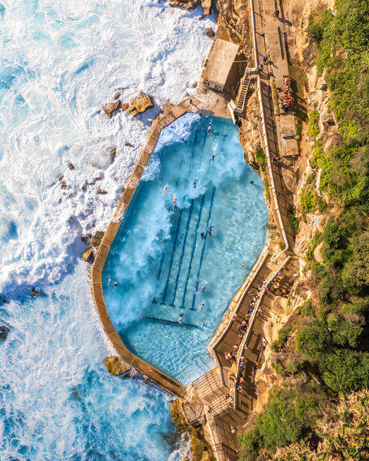 Aerial fine art print of Bronte Beach rock pool with waves crashing – coastal photography from Sydney, Australia