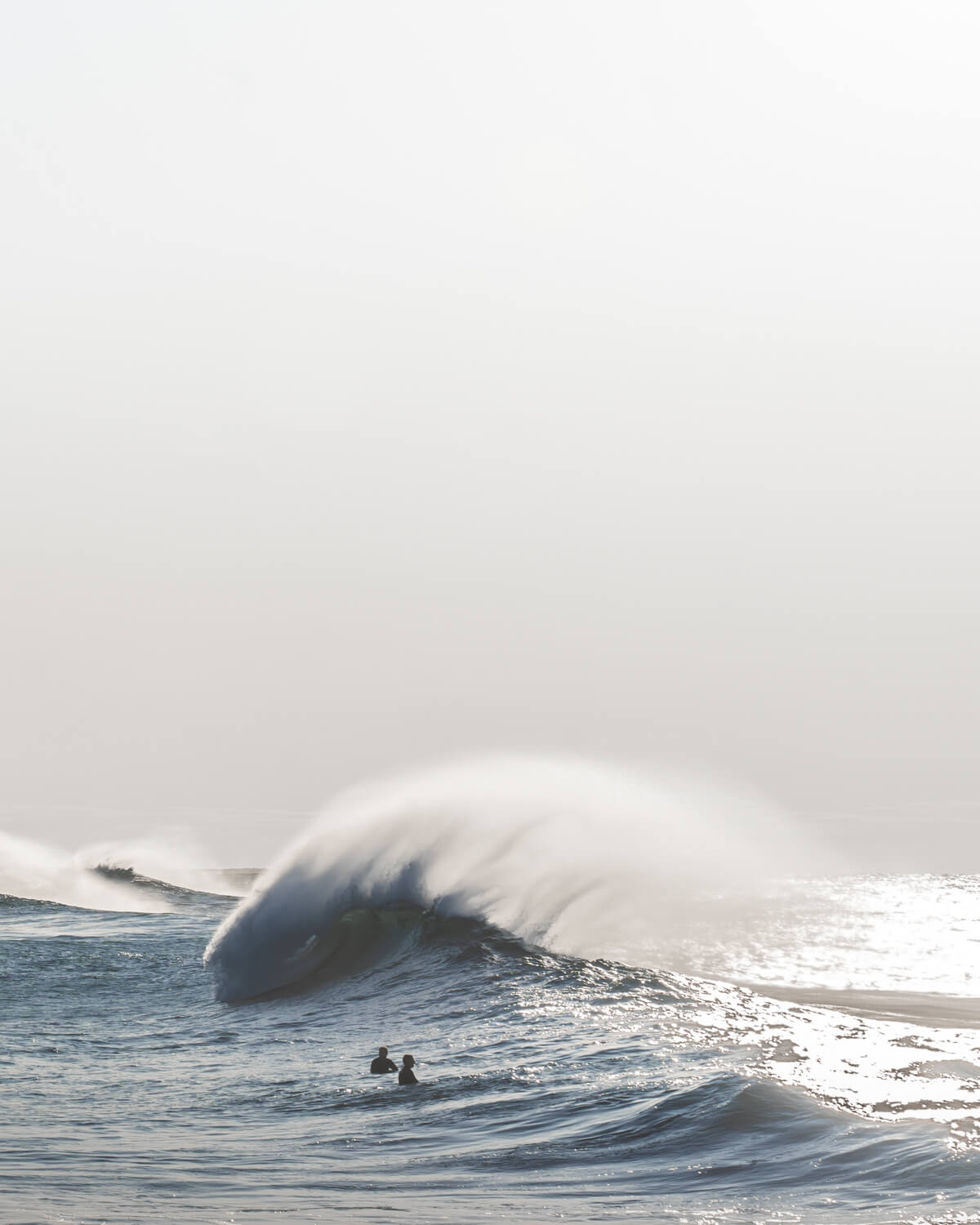 Photo of an early morning winter swell on Sydney’s coast with surfers waiting for waves