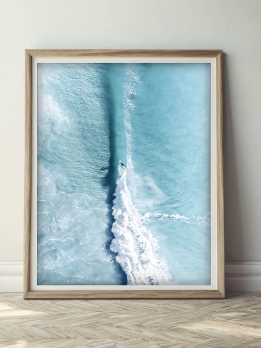 Framed aerial photograph of a surfer riding a wave in Byron Bay