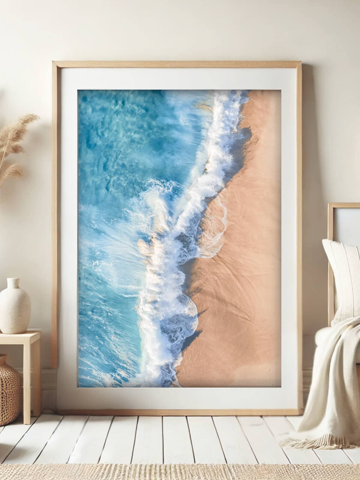 Framed aerial photo of vibrant turquoise waves meeting sandy beach near Byron Bay, capturing a serene coastal view.