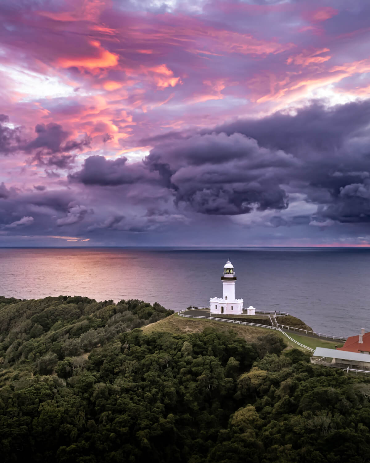 Byron Bay Lighthouse with purple storm clouds rolling in from the ocean during autumn.