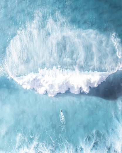 Lone surfer facing a massive wave at Bronte Beach, Sydney, during a big swell.