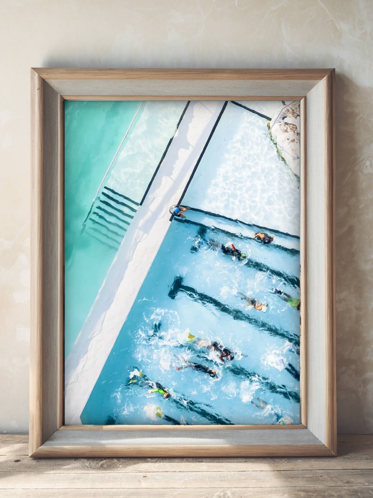 Framed print of Bondi Icebergs Pool aerial view with swimmers in turquoise water.