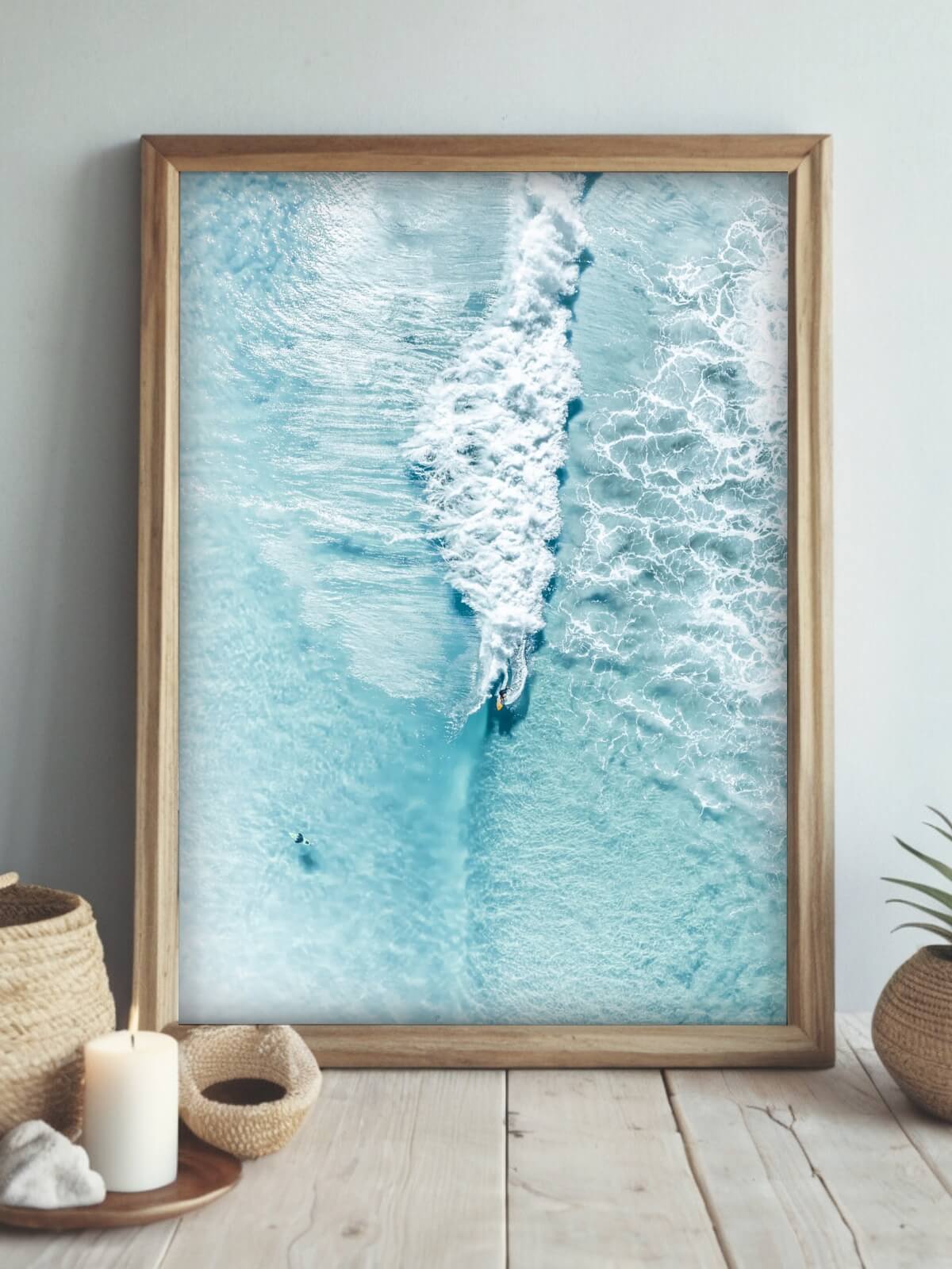 Framed aerial photograph of surfers at The Pass, Byron Bay with blue waves and clear waters.