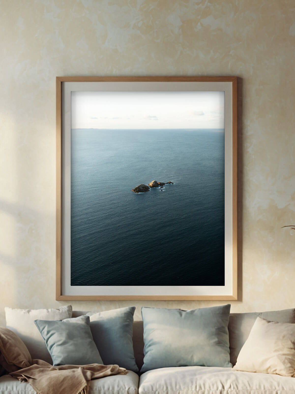 Framed minimalist photograph of Julian's Rocks in Byron Bay, capturing the tranquil ocean expanse and calm horizon in a serene setting.