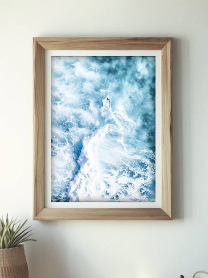 Framed abstract aerial photo of a surfer riding a wave at Bronte Beach, resembling a rocket launch effect.