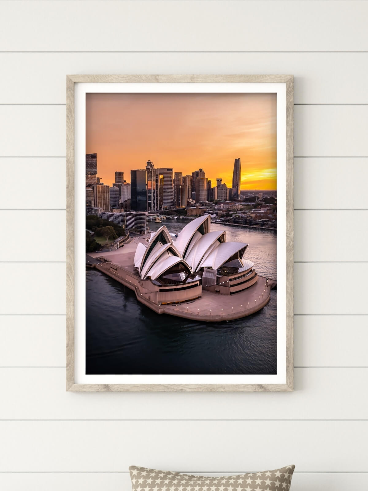 Framed photograph of Sydney Opera House against a vibrant sunset, capturing the iconic skyline and harbor in a serene coastal setting.