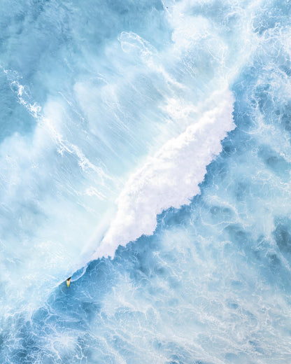 Surfer’s yellow board emerging from a barrel wave during a big swell at Maroubra Beach, Sydney.