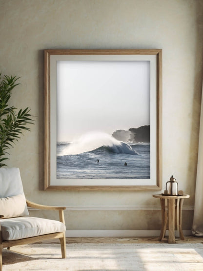 Framed coastal print of a winter swell in Sydney after sunrise, displayed in a cozy, minimalist interior setting.