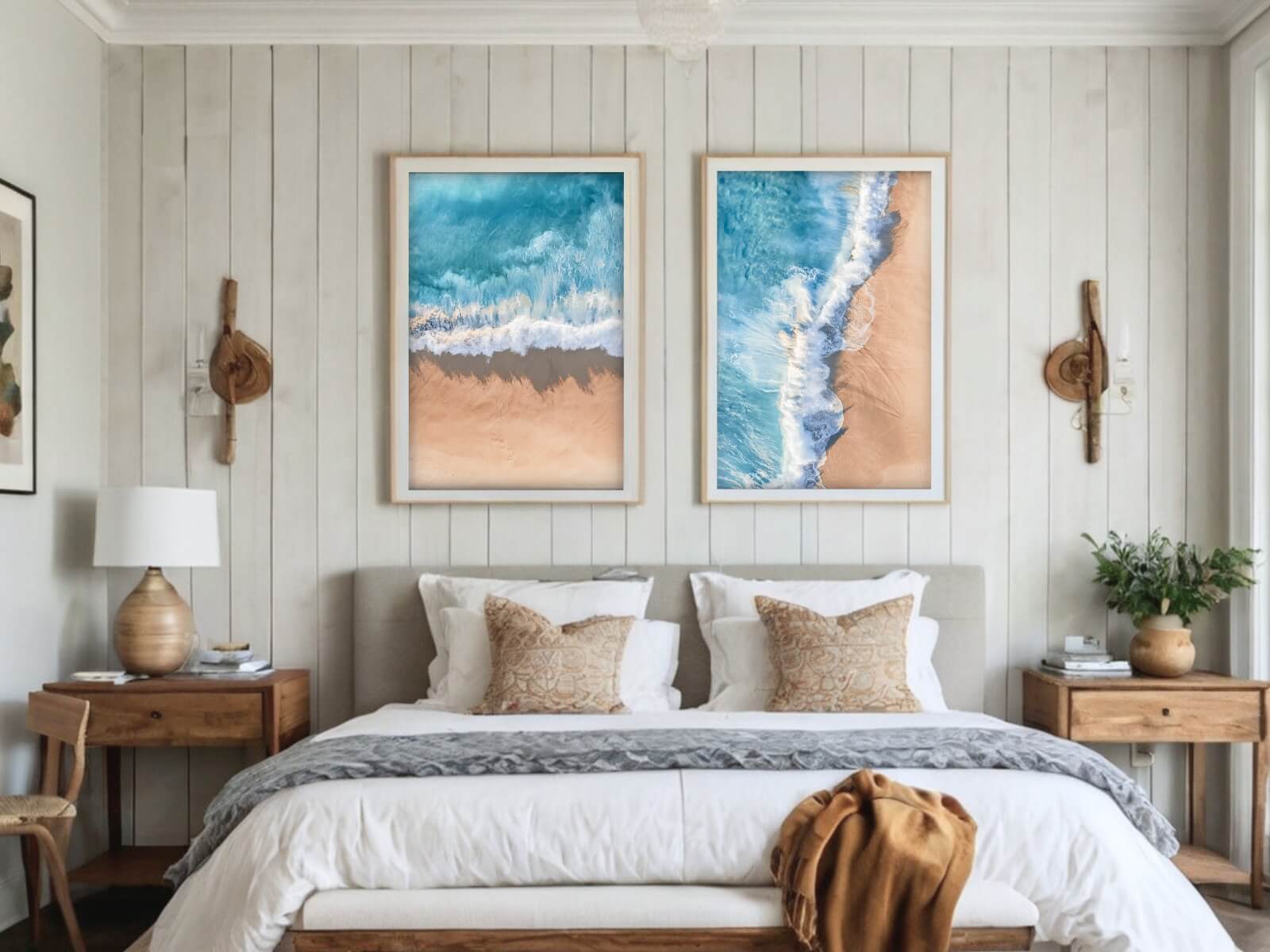 Two big frames of beach photos are placed above a bed.