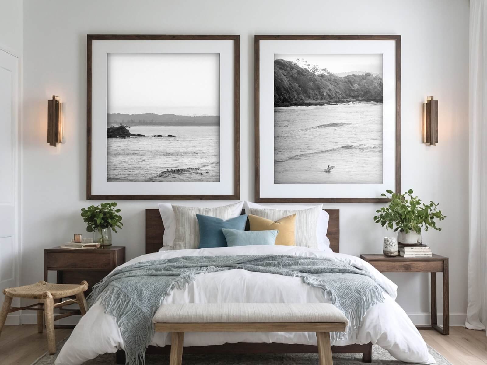 Big frames of black and white surf prints are placed in a cosy bedroom.