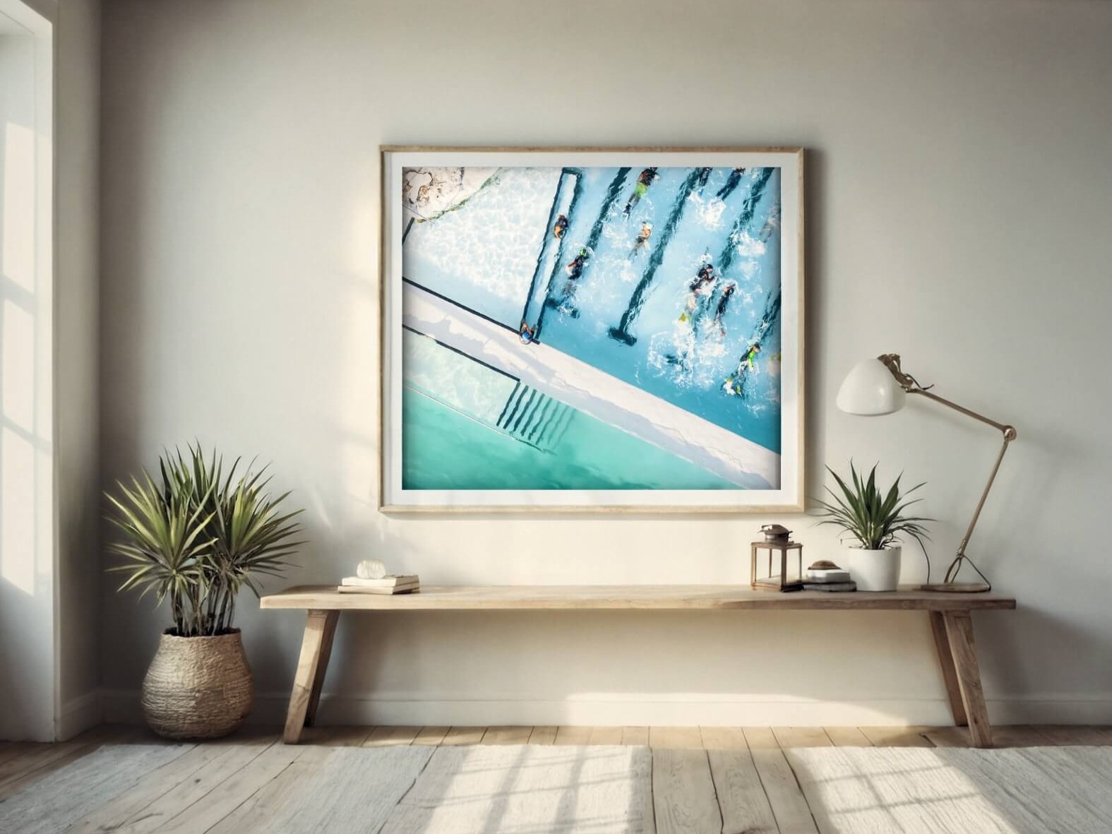 A huge frame featuring the Icebergs rock pool from Sydney is shown against a white wall.