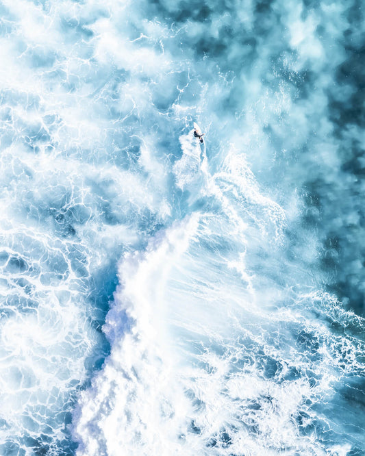 Surfer riding a wave at Bronte Beach with an abstract, rocket-launch-like effect.