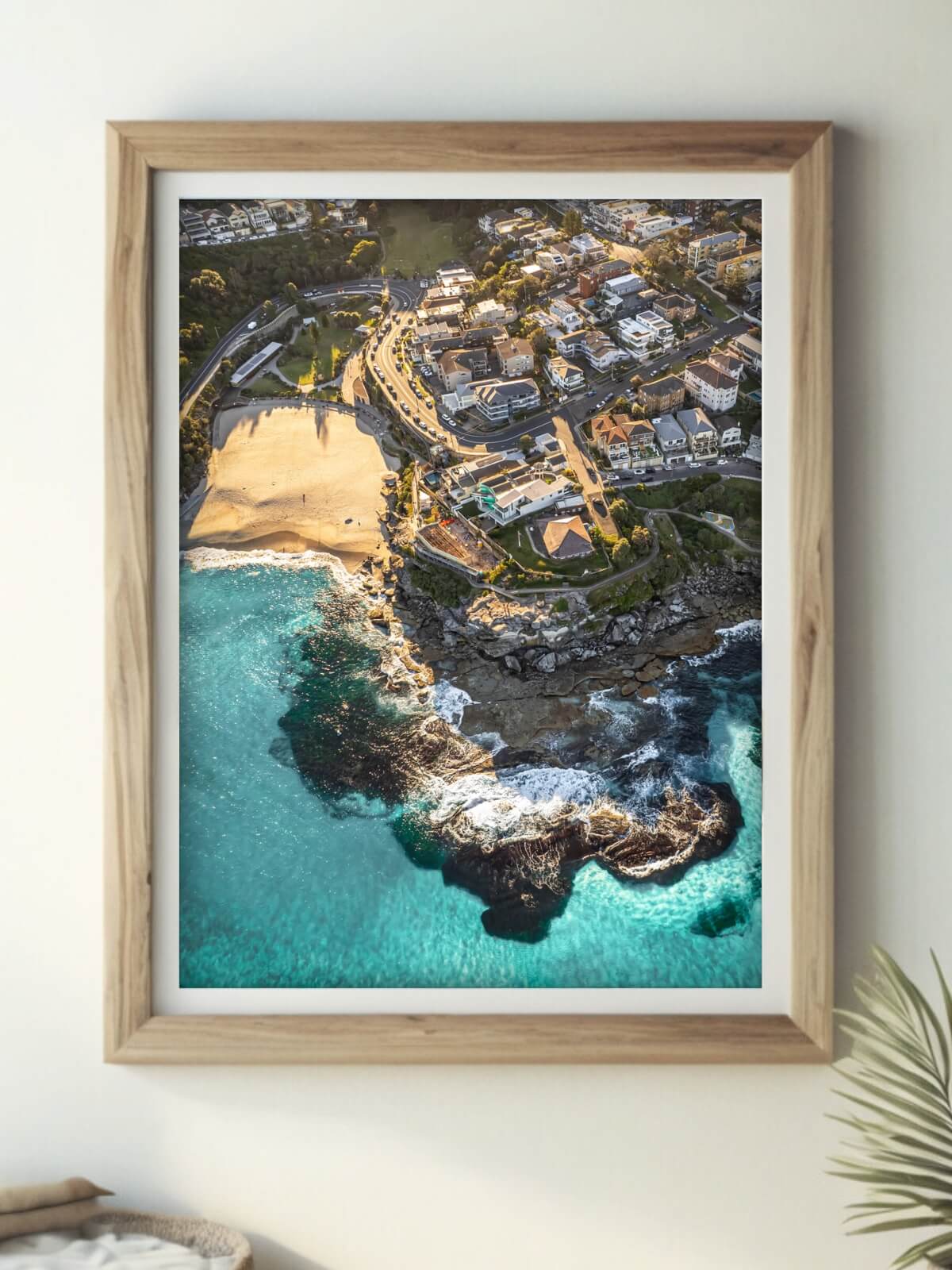 Framed art print of Tamarama Beach, Sydney, displayed in a modern room.